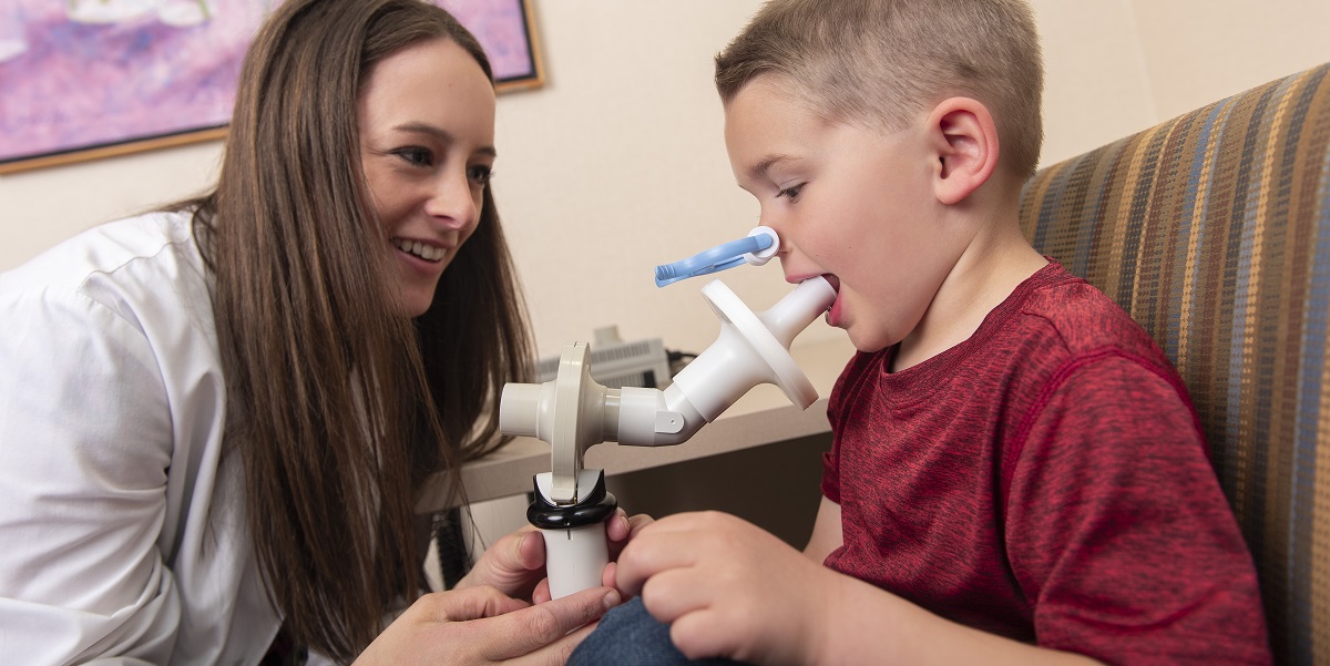 Image of Marshfield Research employee working with a child
