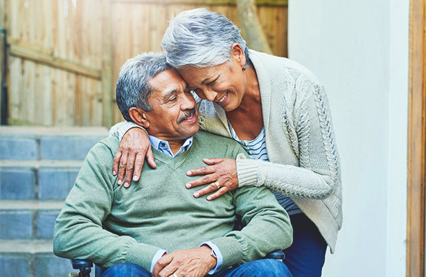 woman hugging man in a wheelchair