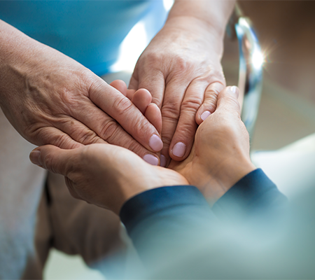 Image of two individuals holding hands